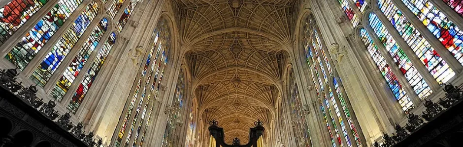 Interior of King's College Chapel at the University of Cambridge, showcasing its Gothic architecture and stained-glass windows.